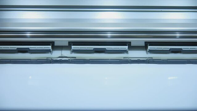 Printing on image on a technological printer. Close up shot of printer
