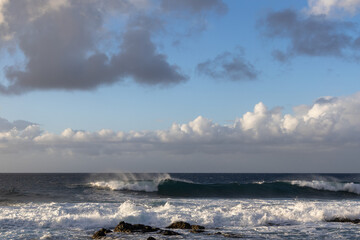 Fototapeta premium Waves rolling in over volcanic rock in Puert de las Nieves, Gran Canaria, Spain