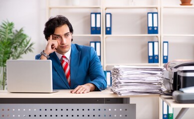 Young employee making copies at copying machine