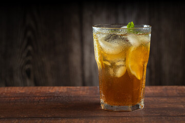 Glass of iced tea with lemon and mint.