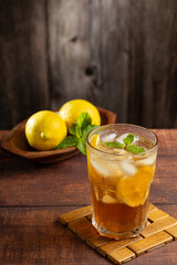 Glass of iced tea with lemon and mint.