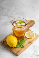 Glass of iced tea with lemon and mint.