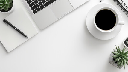 Simple and clean workspace with laptop, coffee cup, and plants