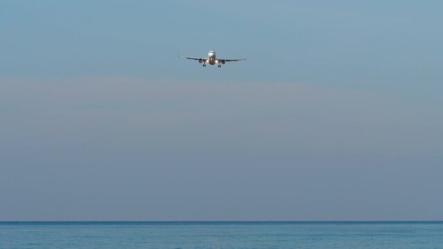Commerical airplane flying with blue sky and sea background. Concept travel and tourism