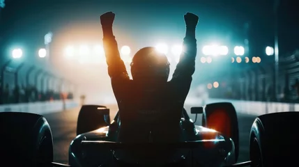 Poster Im Rahmen Silhouette of race car driver celebrating the win in a race against bright stadium lights. 100 FPS slow motion shot © Orxan