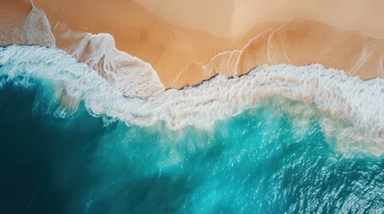 Fotobehang  an aerial view of a beach with waves crashing on the sand and a blue body of water in the foreground. © Anna