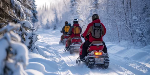 Fotobehang A group of people riding snowmobiles at a nordic coutry and make an outdoor adventure between the snowy woods © Erzsbet