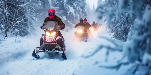 Fotobehang A group of people riding snowmobiles at a nordic coutry and make an outdoor adventure between the snowy woods © Erzsbet