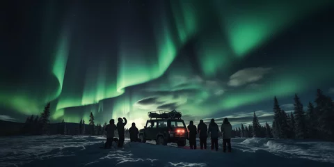 Deurstickers A group of tourist are watching the northern light aurora borealis at a northern light guided tour with bus © Erzsbet