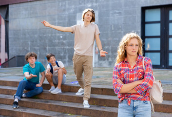 Portrait of offended girl after quarrel with friends outdoors