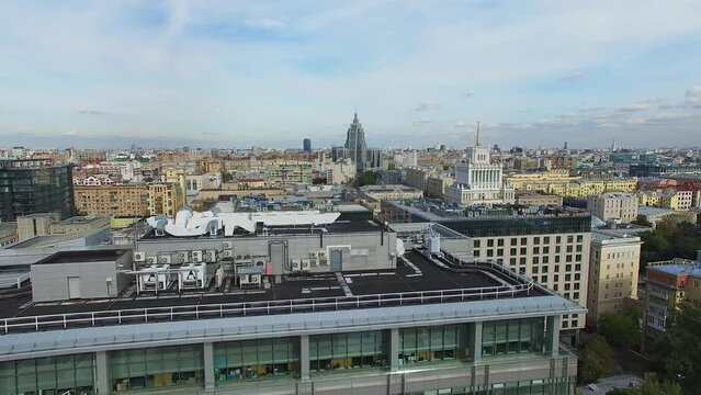 Cityscape and roof of business center with ventilation system. Aerial view