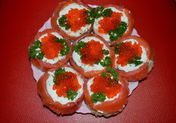 Cottage cheese snack with red fish seeds red caviar and parsley. Delicious curd snack with red smoked fish and red caviar