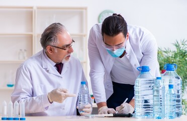 Two chemists working in the lab