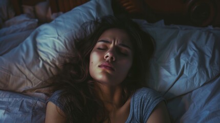 A peaceful portrait of a woman, enveloped in the warmth of her bedclothes, lost in comfortable slumber with her eyes closed and her delicate skin glowing in the soft indoor light
