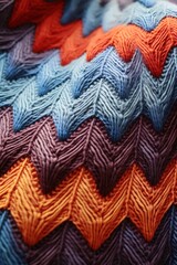 vertical image blue, brown and orange knitted wool fabric macro texture background, soft and cozy weave patterned surface