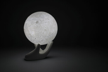 Night light full moon. Statuette of full moon. Moon surface. - obrazy, fototapety, plakaty