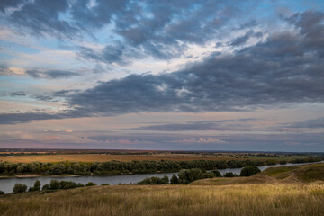 clouds over the river, evening over the river, view from the hill to the endless expanses of fields
