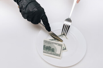 Business lunch concept. Female hands in black gloves hold fork with knife and cut off a piece from...