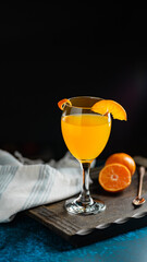 Orange juice in a glass on a dark background. Selective focus.