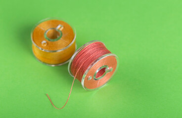 Plastic bobbins for a sewing machine with multi-colored threads.