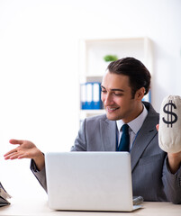 Young male accountant working in the office