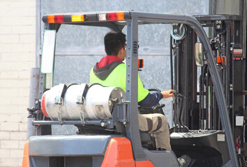 A man driving a fork lift