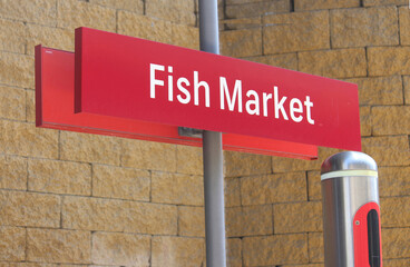 Orange Fish Market signage on a pole at the light rail station - Powered by Adobe