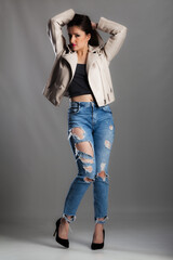 full body poirtrait of a beautiful girl with long hair wearing jeans and jacket