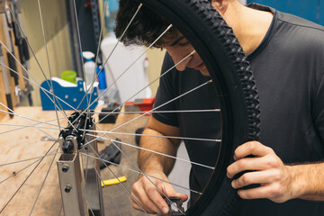mechanic boy centering bike wheel