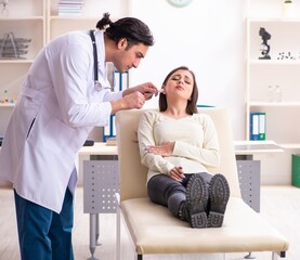 Young male doctor and female beautiful patient