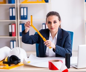 Young female architect working in the office