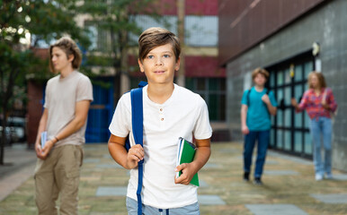 Portrait of teenager boy going to school lessons on sunny summer day