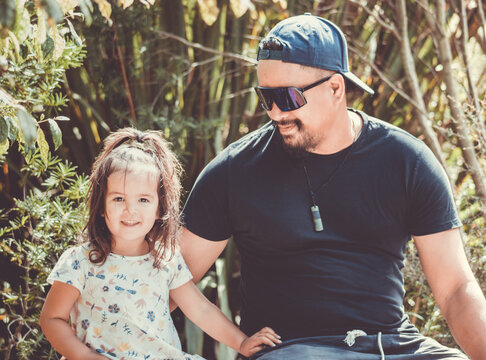 a close up image of a Maori father and daughter posing for their photograph to be taken.