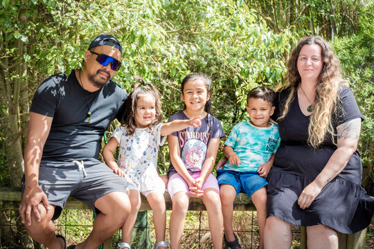 A close up portrait of young multiracial New Zealand family.