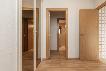 Home hall with mirror doors in a built-in wardrobe