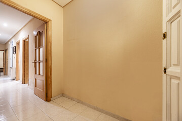 Hallway of a home with light stoneware floors, walls painted