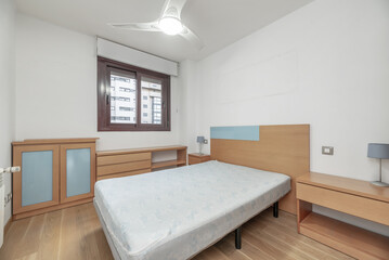 A bedroom with light wooden furniture