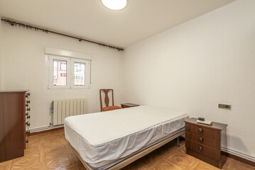 Fototapeta na wymiar Bedroom without bedding on the double mattress