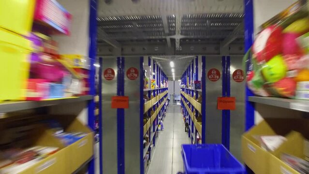 Many goods lay on shelves in internet shop storage facilities of Ozon company
