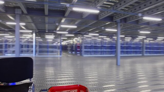 Work place with computer in ware house with many empty shelves