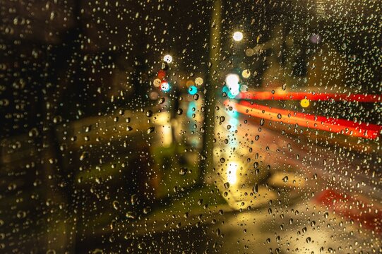 Water droplets on window pane at night with light traces of passing cars, Jena, Thuringia, Germany, Europe
