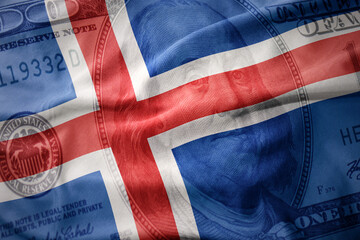 waving colorful flag of iceland on a american dollar money background. finance concept.
