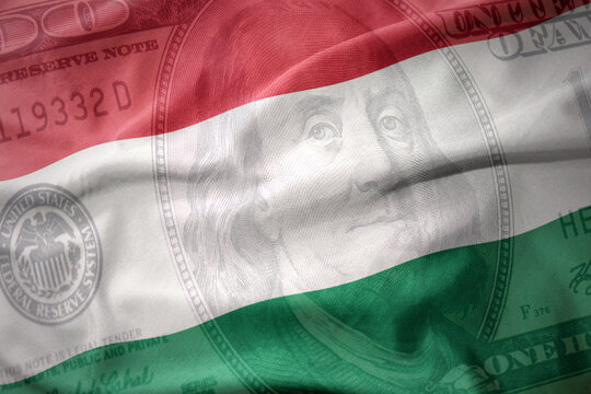 waving colorful flag of hungary on a american dollar money background. finance concept.
