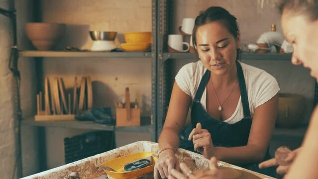 Pottery wheel, teaching or women mold clay, design sculpture or unique artwork in studio workshop. Ceramic, artisan or teacher form handmade product, project or mud art for student learning handcraft