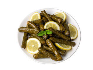 Delicious dolma (sarma) stuffed grape leaves rice, white yogurt sauce. Lebanese dolma sarma on plate. Lebanon turkish greek middle eastern cuisine. (Turkish name; Yaprak sarma)