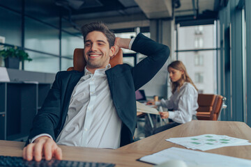 Happy businessman having rest after successful negotiations and contracting. Business concept