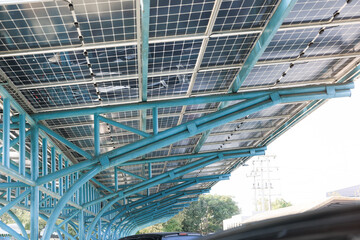 Solar car parking or parking lot at outdoor. Roof canopy covered or construction from solar panel. Innovation system technology to generate electricity from light. Concept of green clean power energy. - obrazy, fototapety, plakaty