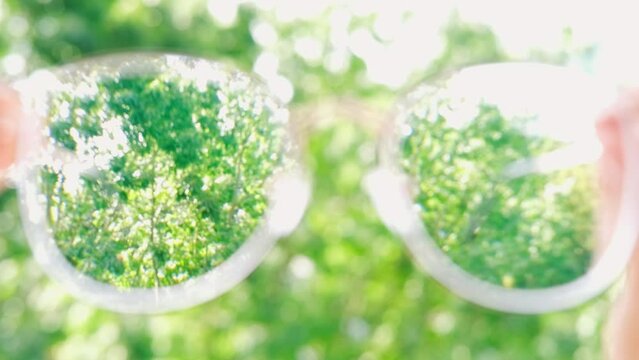 glasses with thin metal frame in female hands, individuals with poor vision adapt lifestyle choices and habits accommodate visual needs