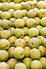 Closeup of a tray of pears at a farmer's market.