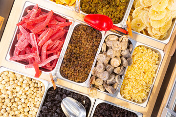 Mixed trays of dried fruit and nuts in a Middle Eastern Grocery Store. 